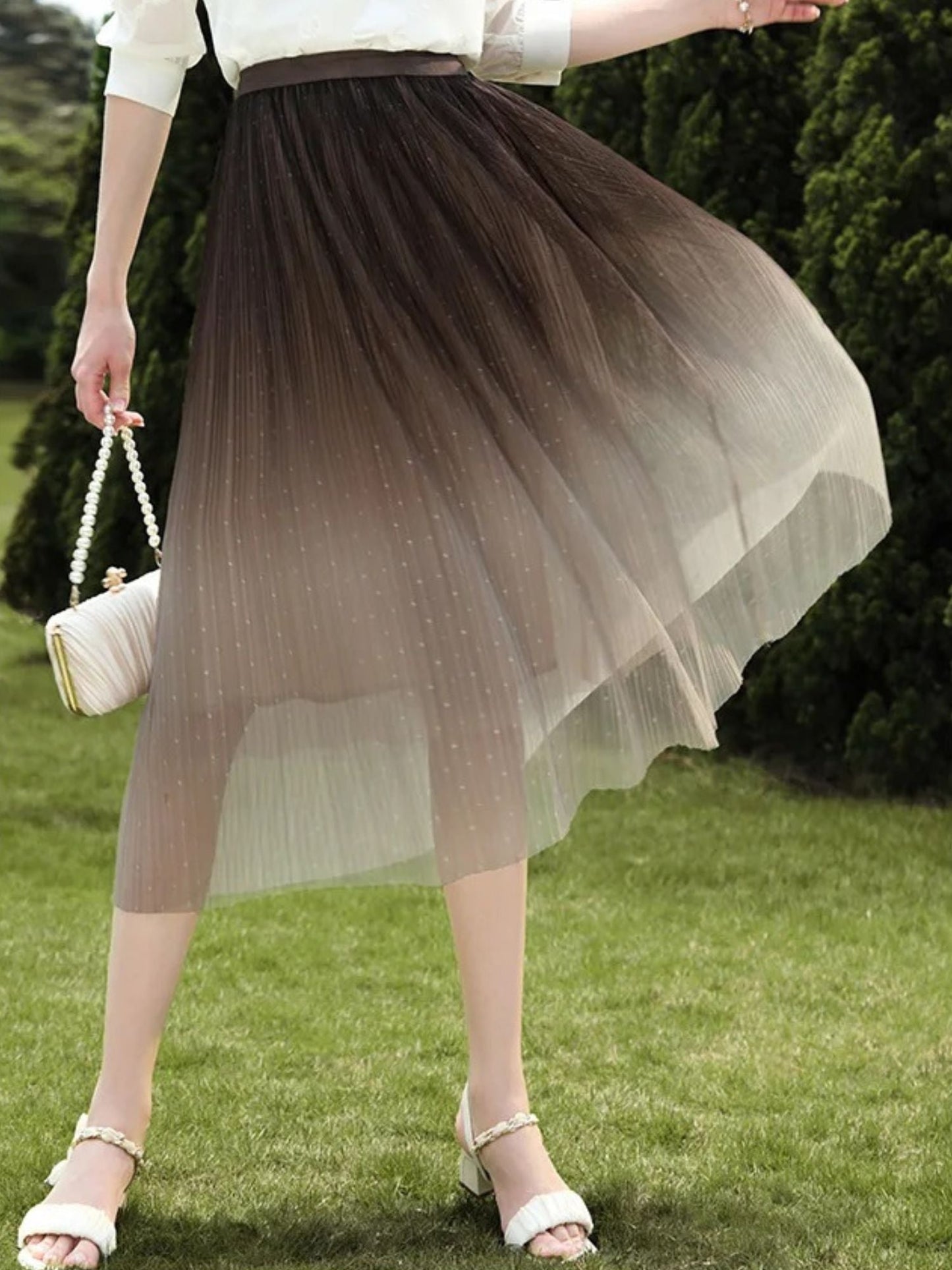 A woman wearing an ombre color tule midi skirt.