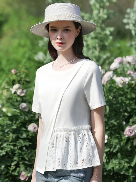 A woman wearing a pleated t-shirt with eyelet details.