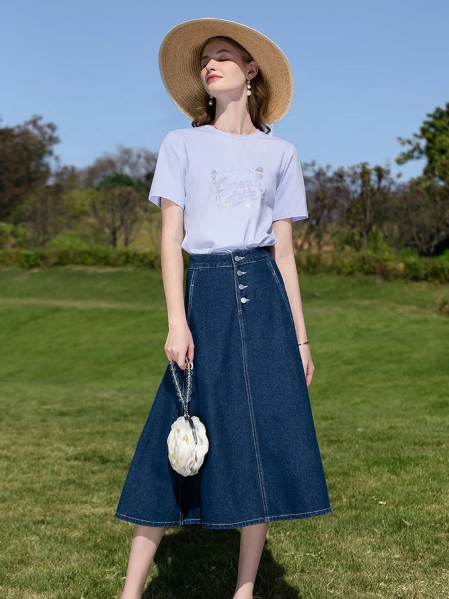 A woman wearing a vintage high waisted denim midi skirt.