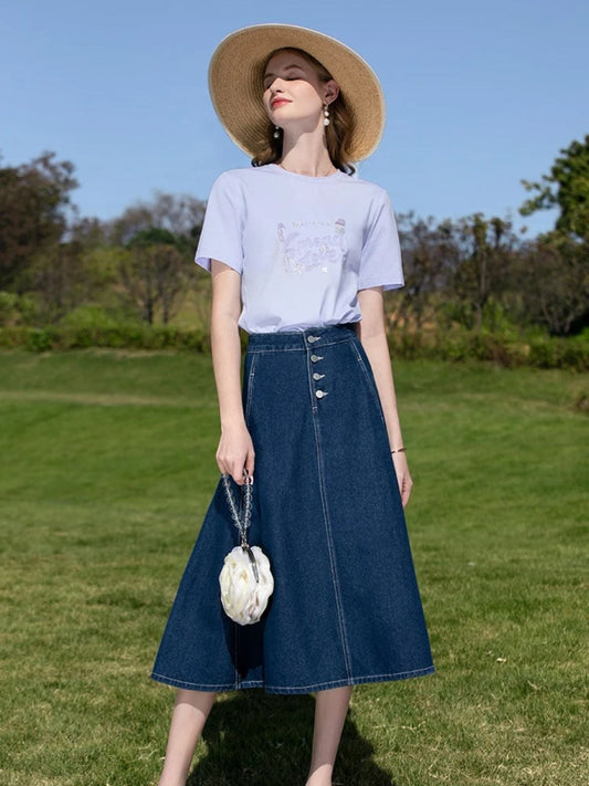A woman wearing a vintage high waisted denim midi skirt.