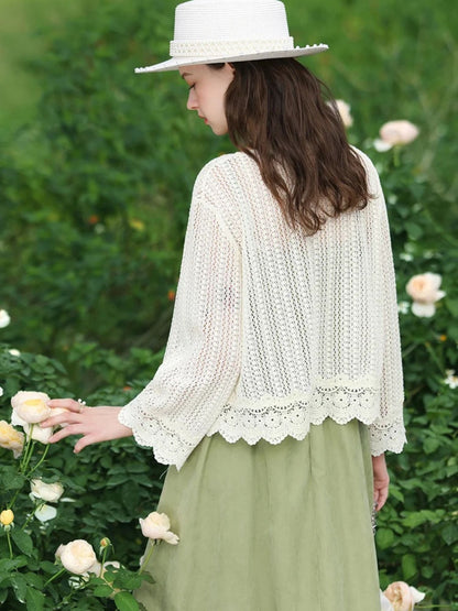 A woman wearing a lightweight eyelet cardigan