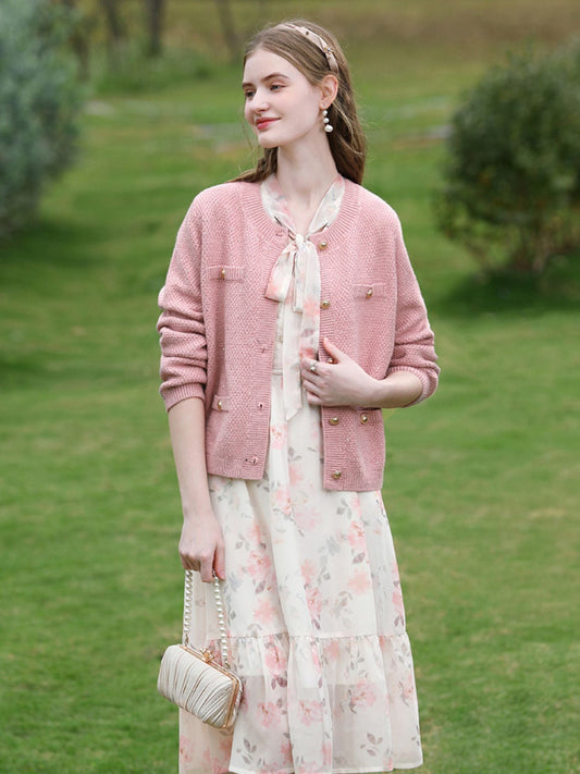 A woman wearing a tweed knit cardigan.