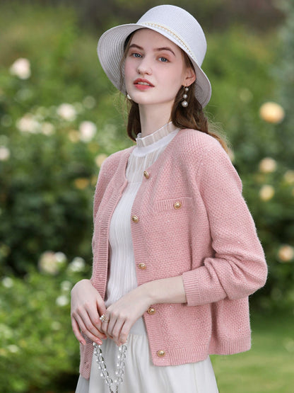A woman wearing a tweed knit cardigan.
