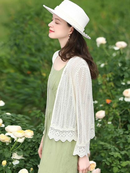 A woman wearing a lightweight eyelet cardigan