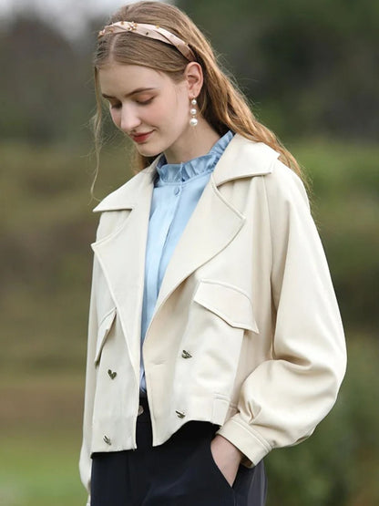 A woman wearing a sleeveless blouse with a ruffled collar design.