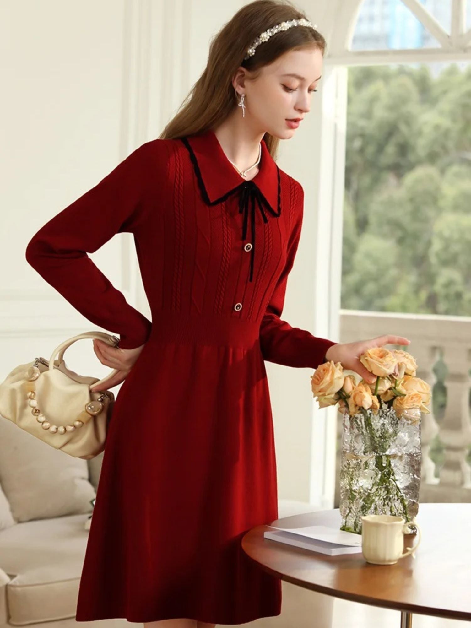 A young lady wearing a vintage red knit dress.