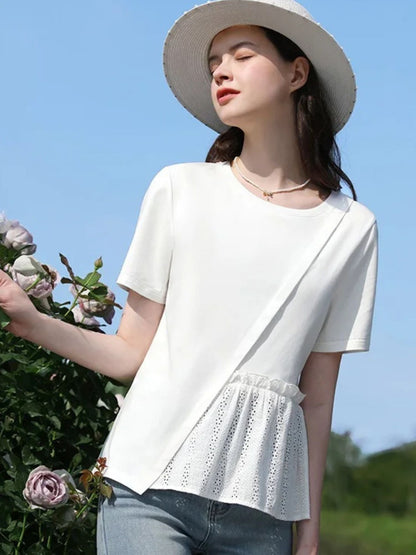 A woman wearing a pleated t-shirt with eyelet details.