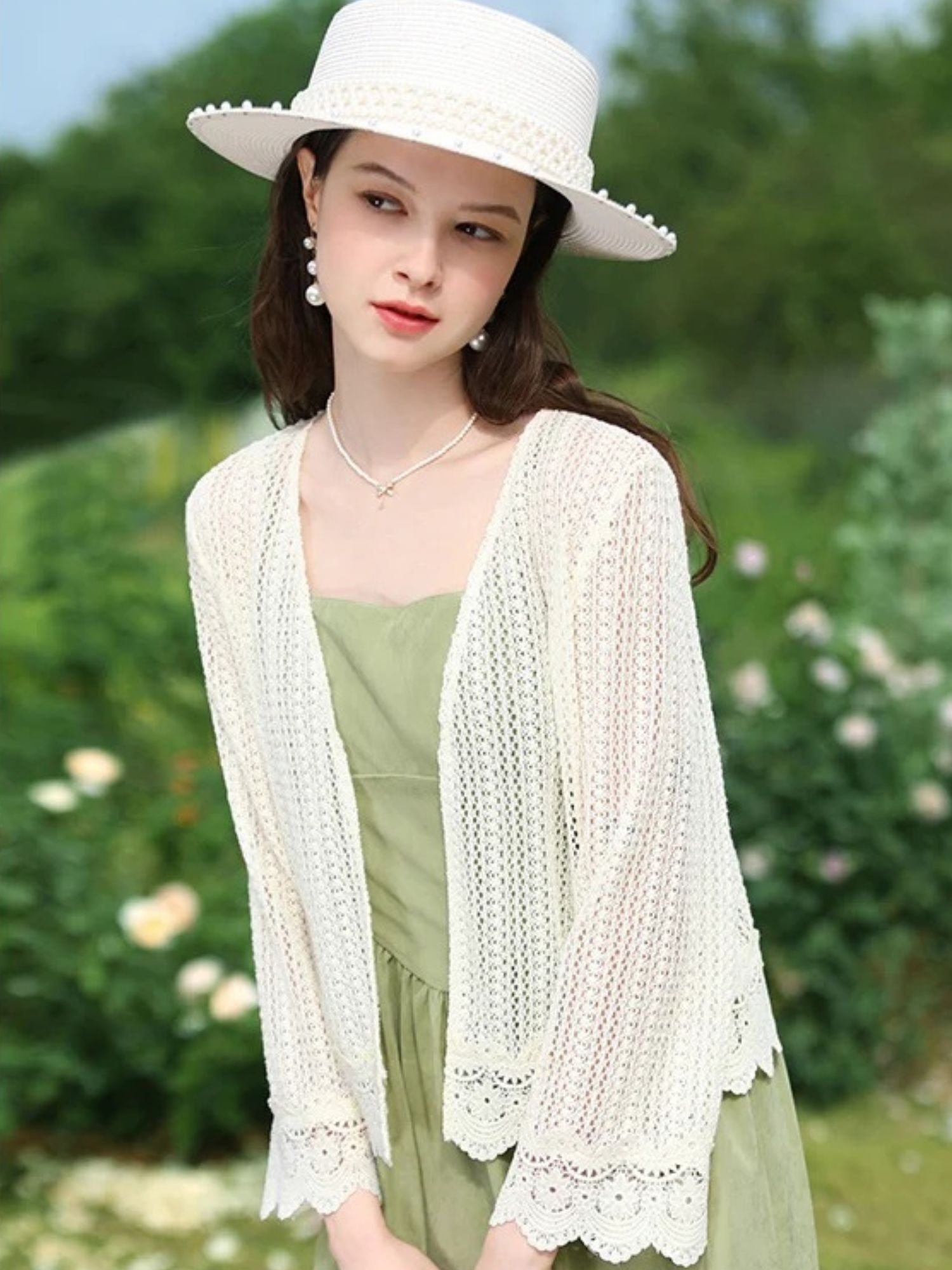 A woman wearing a lightweight eyelet cardigan