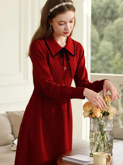 A young lady wearing a vintage red knit dress.