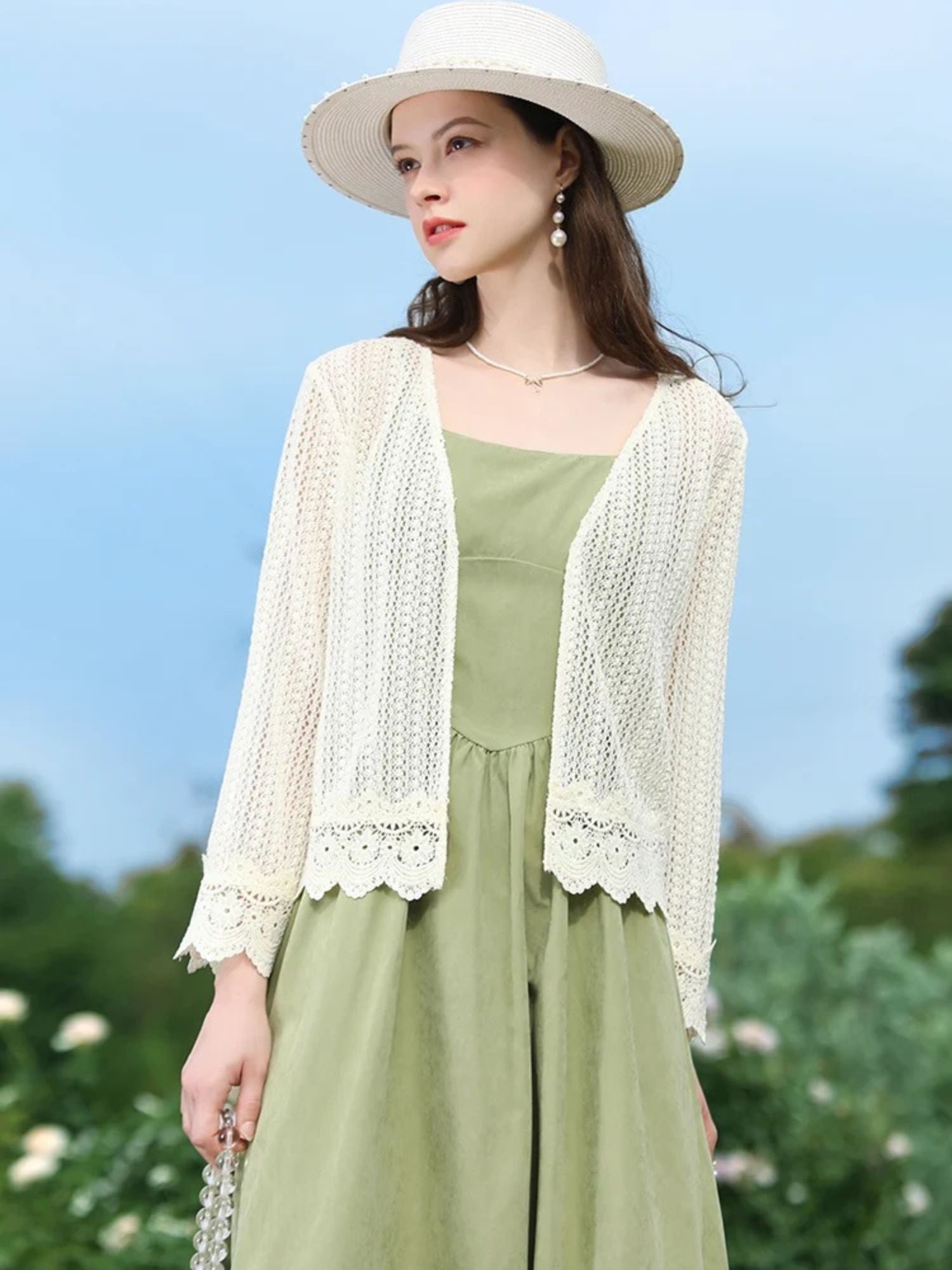 A woman wearing a lightweight eyelet cardigan