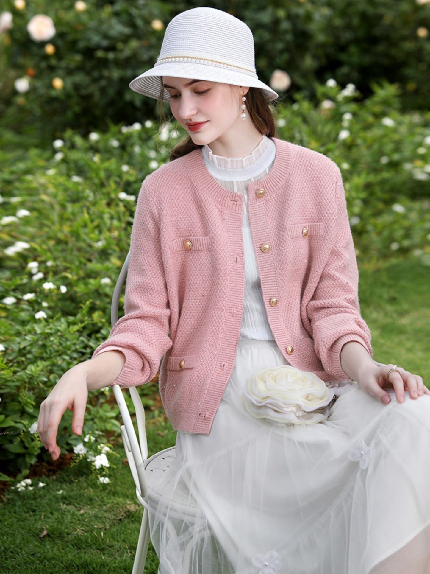 A woman wearing a tweed knit cardigan.