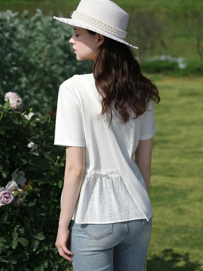 A woman wearing a pleated t-shirt with eyelet details.