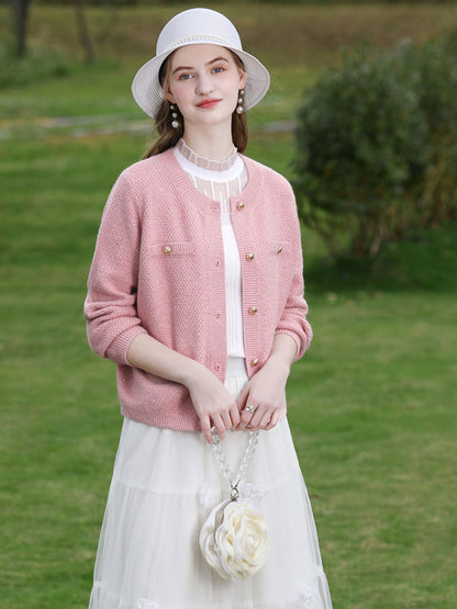 A woman wearing a tweed knit cardigan.