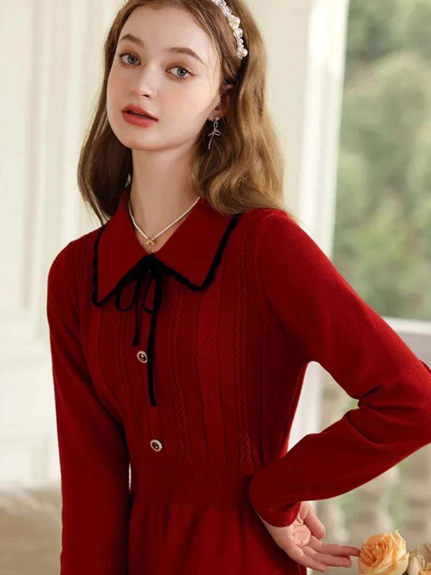 A young lady wearing a vintage red knit dress.