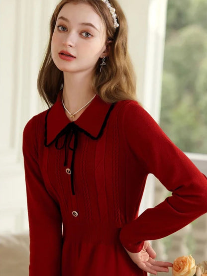 A young lady wearing a vintage red knit dress.