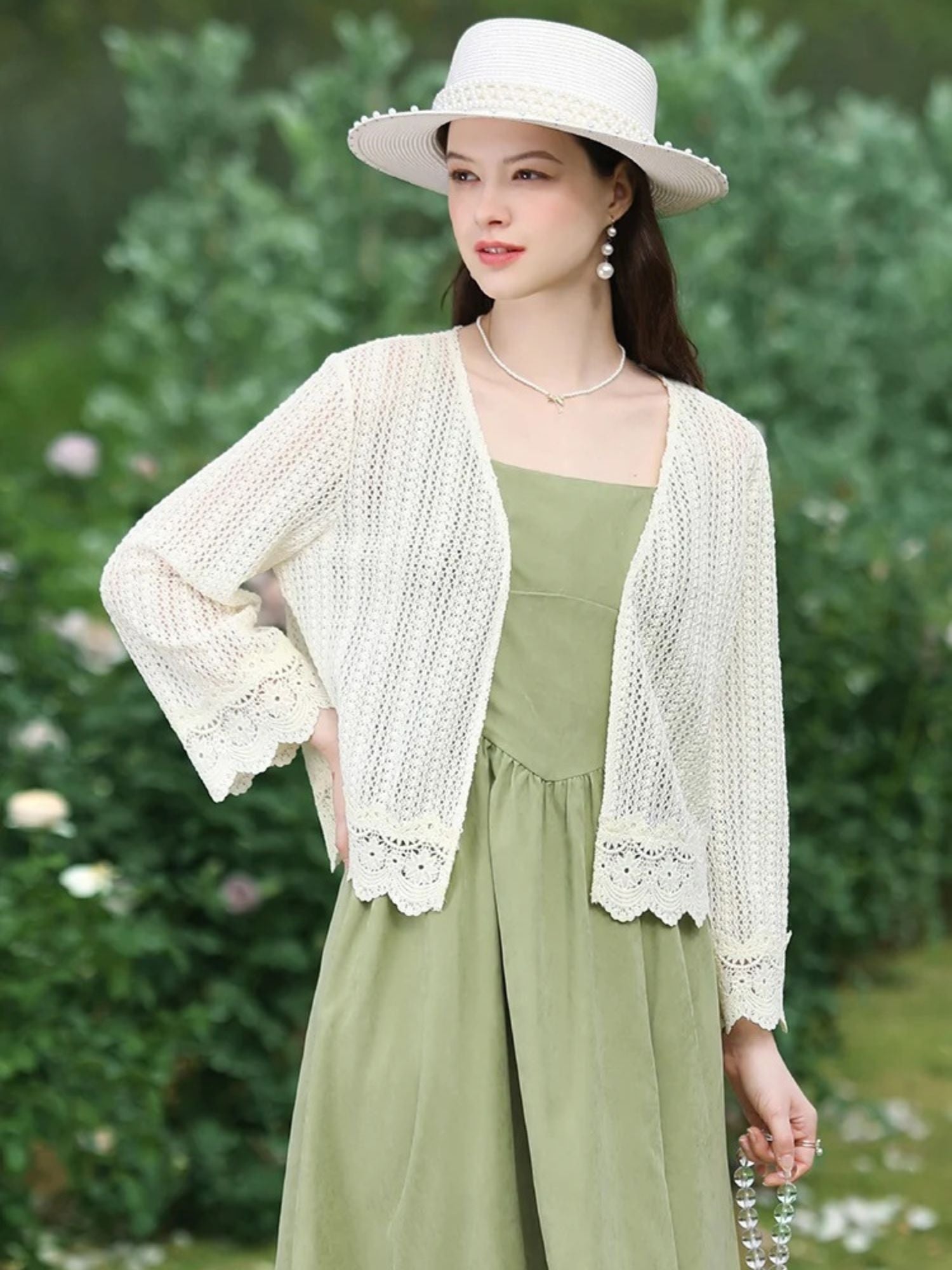 A woman wearing a lightweight eyelet cardigan