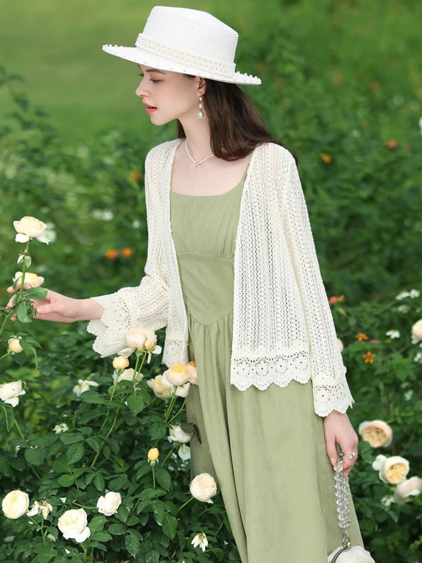 A woman wearing a lightweight eyelet cardigan