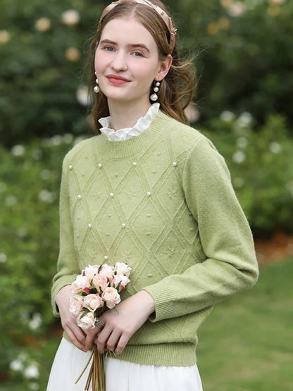 A woman wearing a sleeveless blouse with a ruffled collar design.